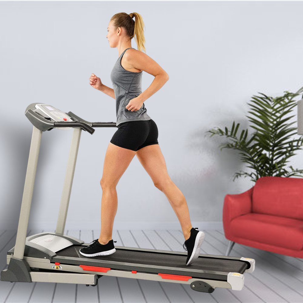 A foldable home treadmill set up in a living room